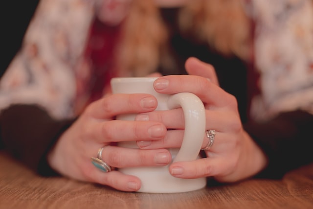 cold hands and feet, woman holding a mug